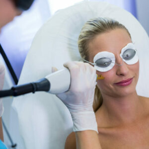 Woman receiving laser epilation treatment on her face at beauty salon